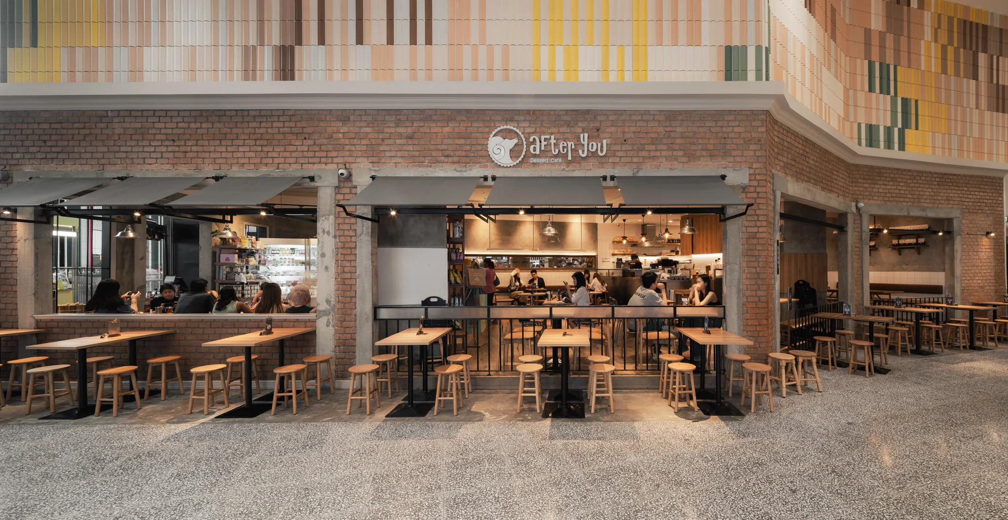 Wide open brick frontage of After You CentralWorld in Bangkok.