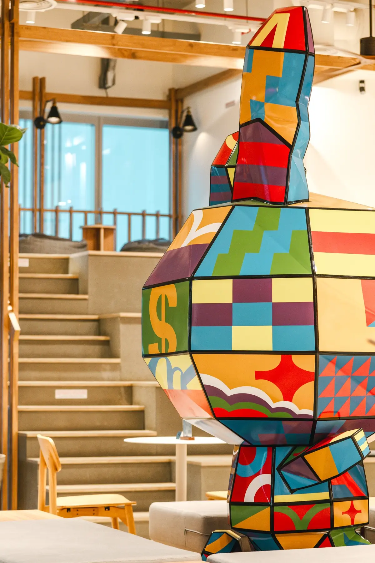 Geometric sculpture integrated beside the timber steps