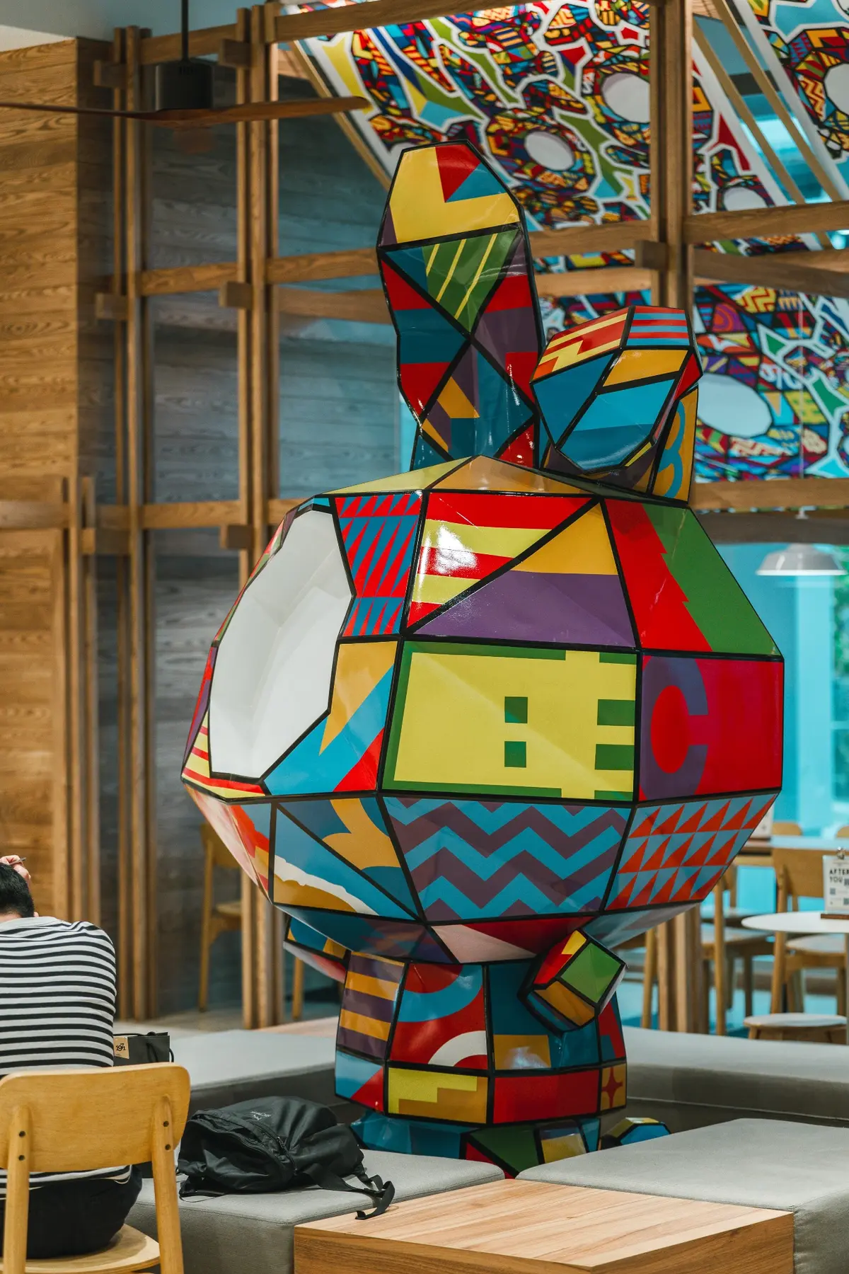 Sculpture framed by the timber interior system