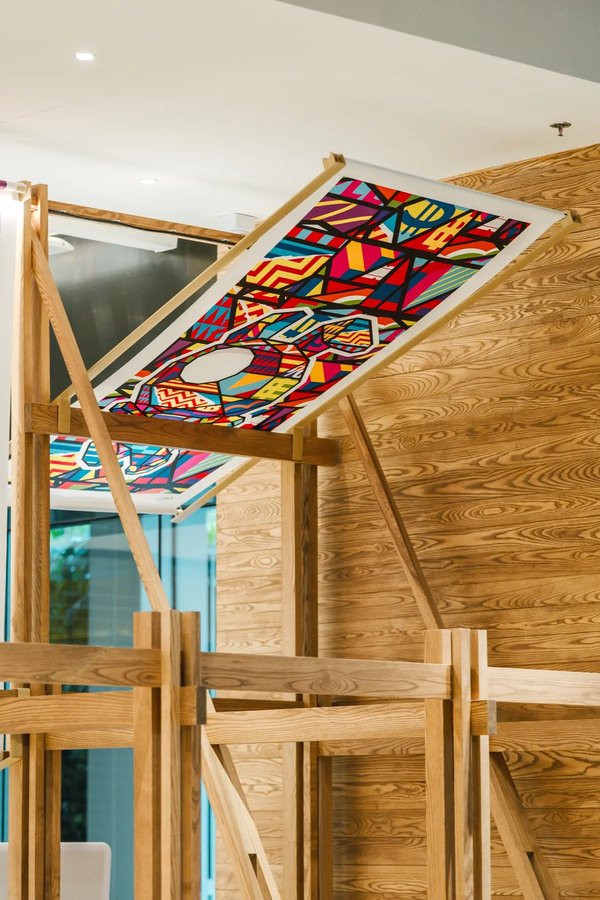 Artwork canopy mounted over a timber seating bay