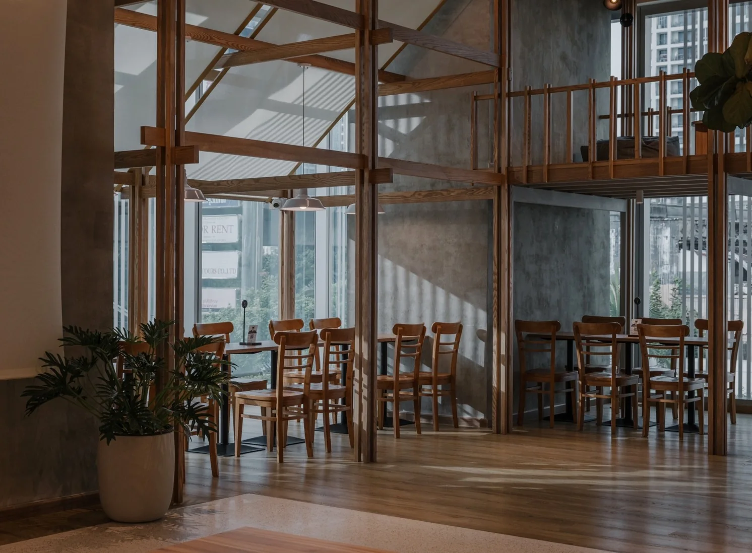 Window-side cafe seating framed by timber structure
