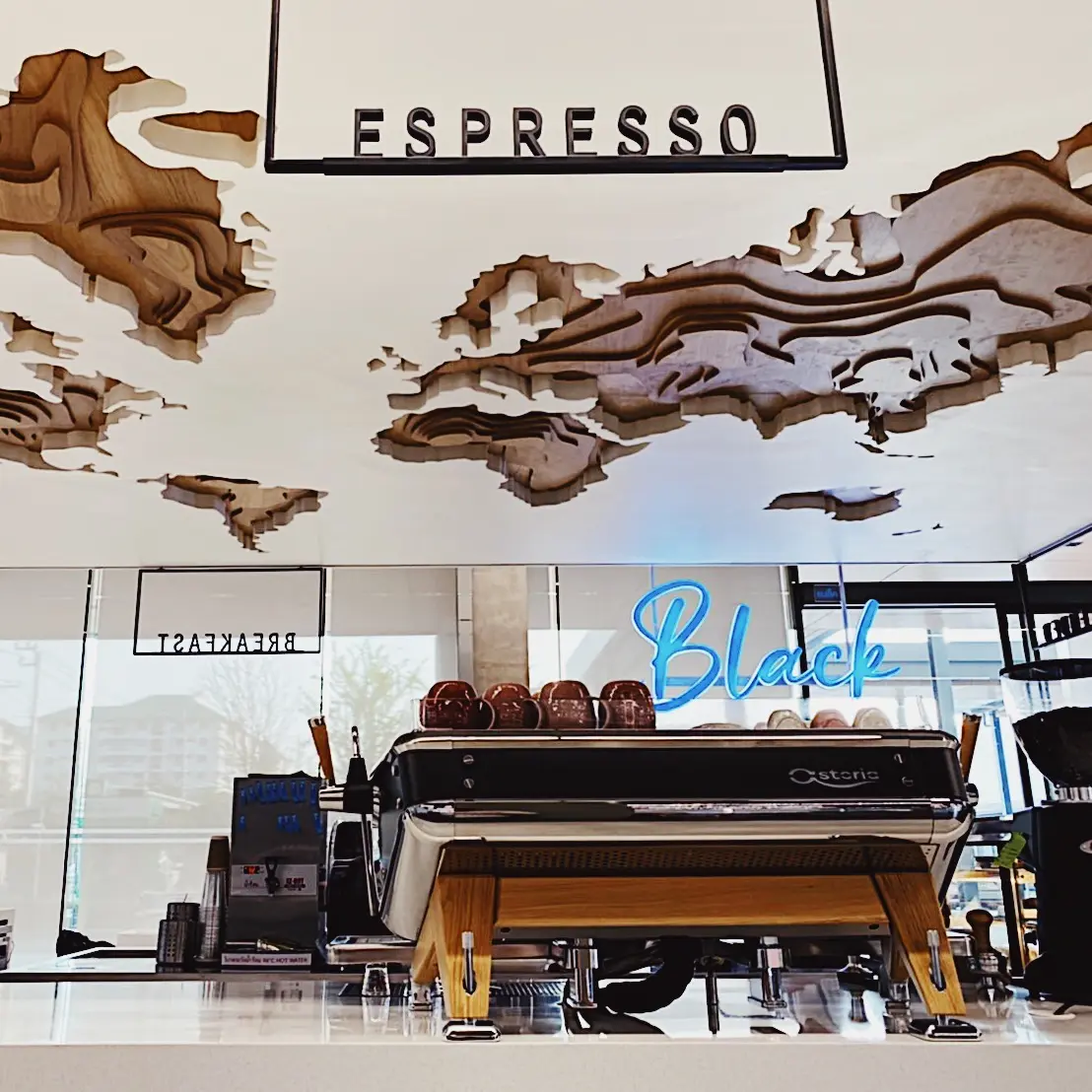 Black Coffee espresso counter with layered ceiling above