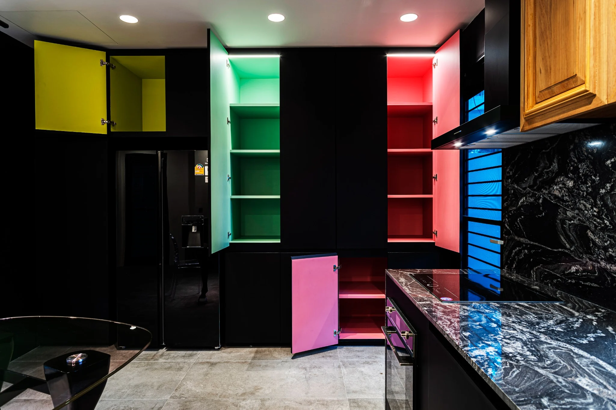 Indy's Scape kitchen with black cabinetry, bright inner cabinet colors and timber doors