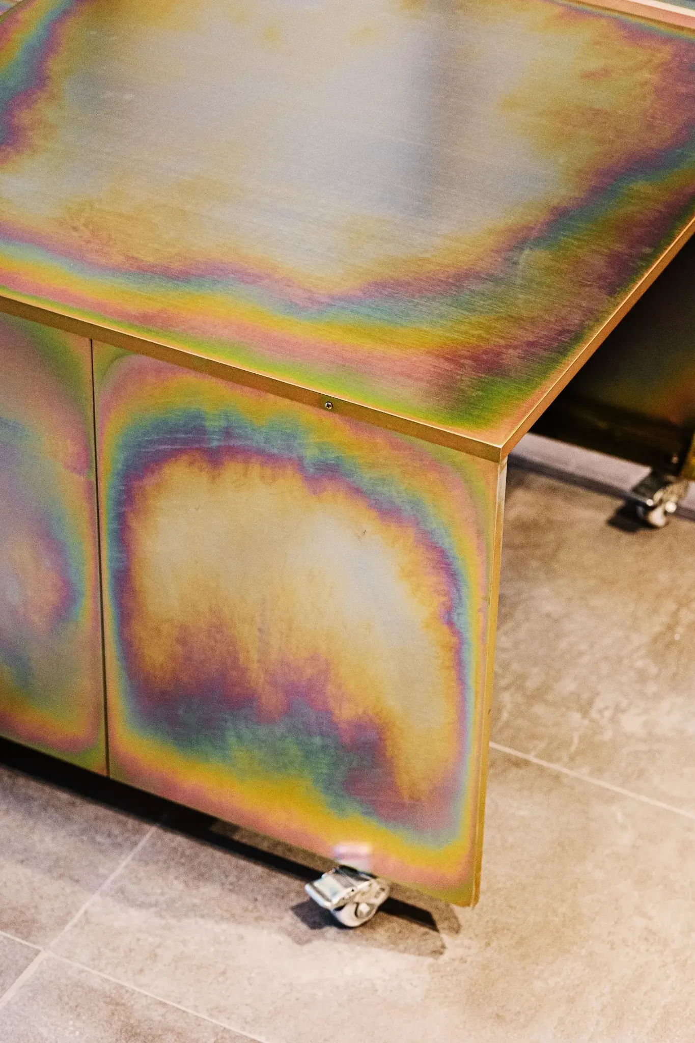 Custom iridescent steel cabinet detail on wheels at Indy's Scape