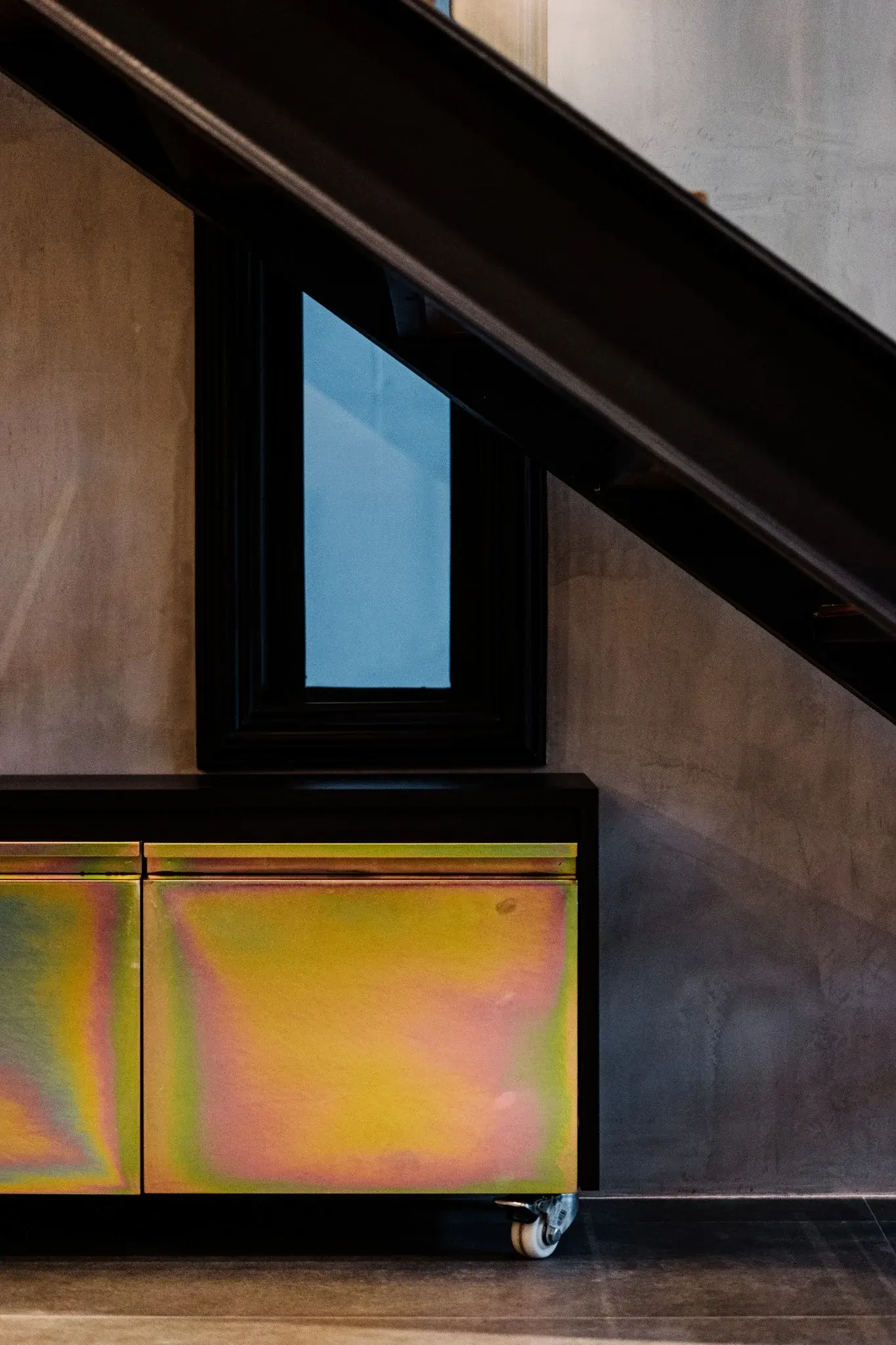 Iridescent cabinet beneath stair at Indy's Scape