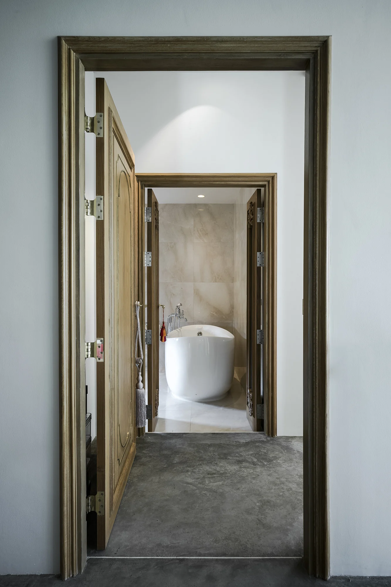 Kitisook House bathroom framed by timber doors