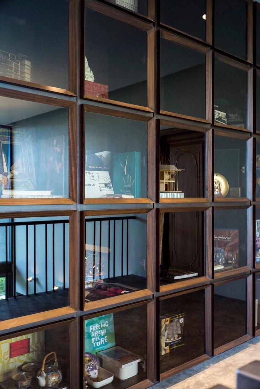 Dark timber and glass display wall at Kitisook House