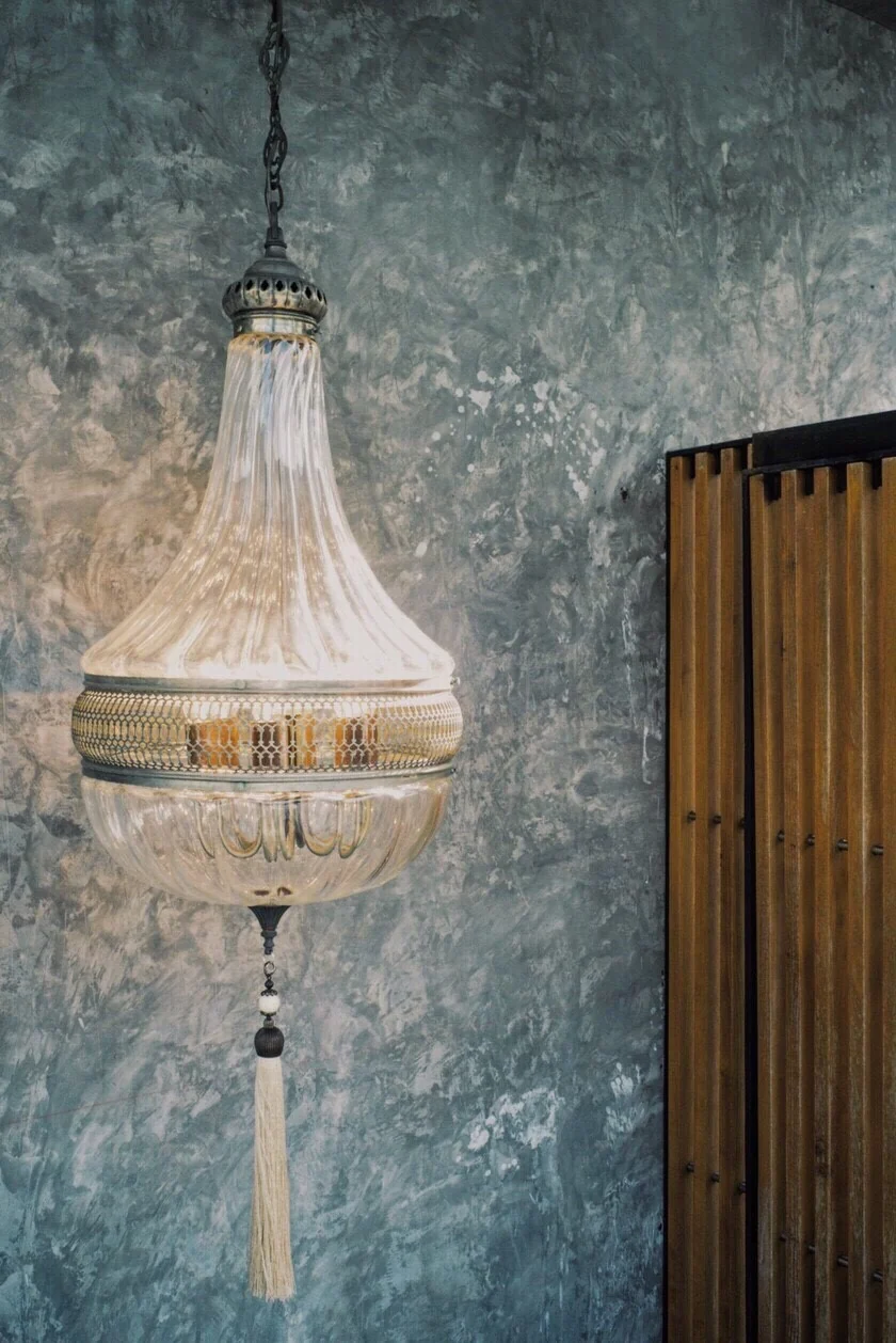 Decorative pendant lamp against textured concrete wall