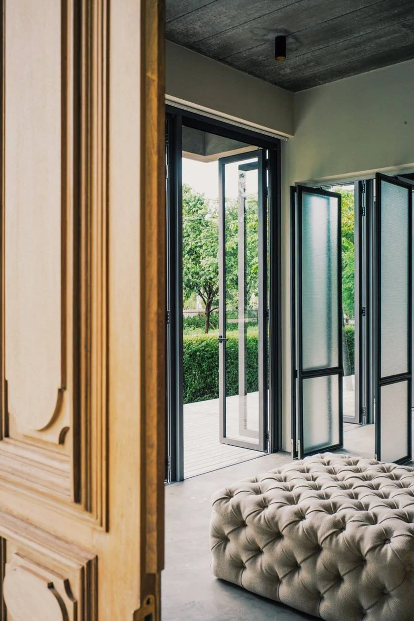 Bedroom joinery, upholstered bench and folding glass doors at Kitisook House
