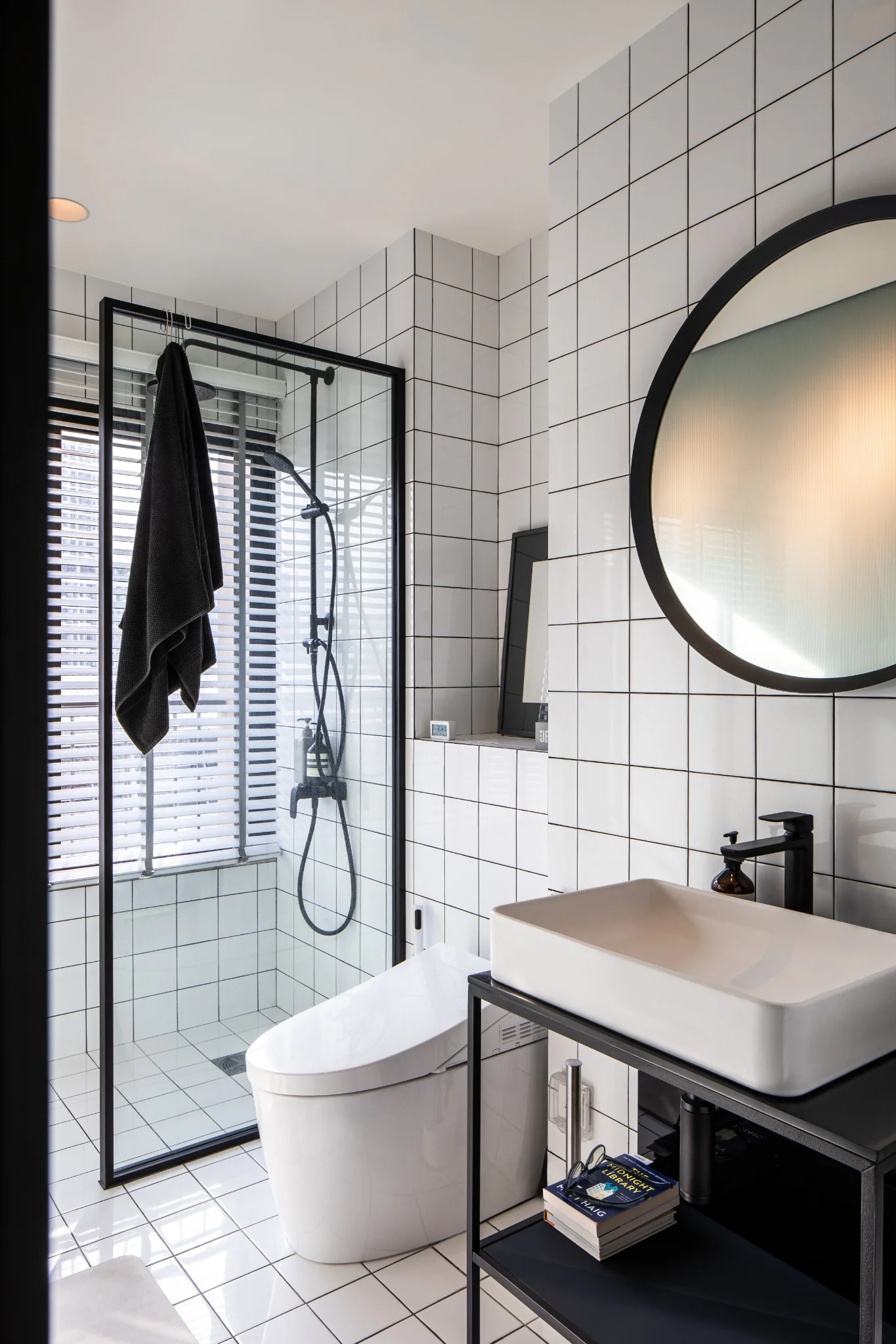 Noble Revent bathroom with black frame and white tile
