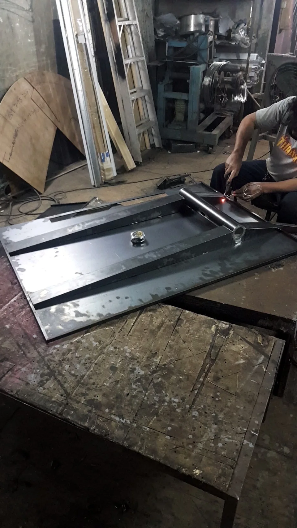Rotating TV stand being fabricated in a local metal workshop