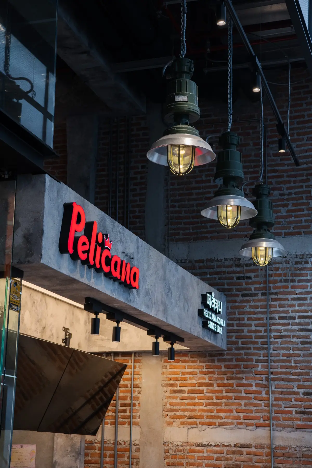 Workshop lights over Pelicana sign