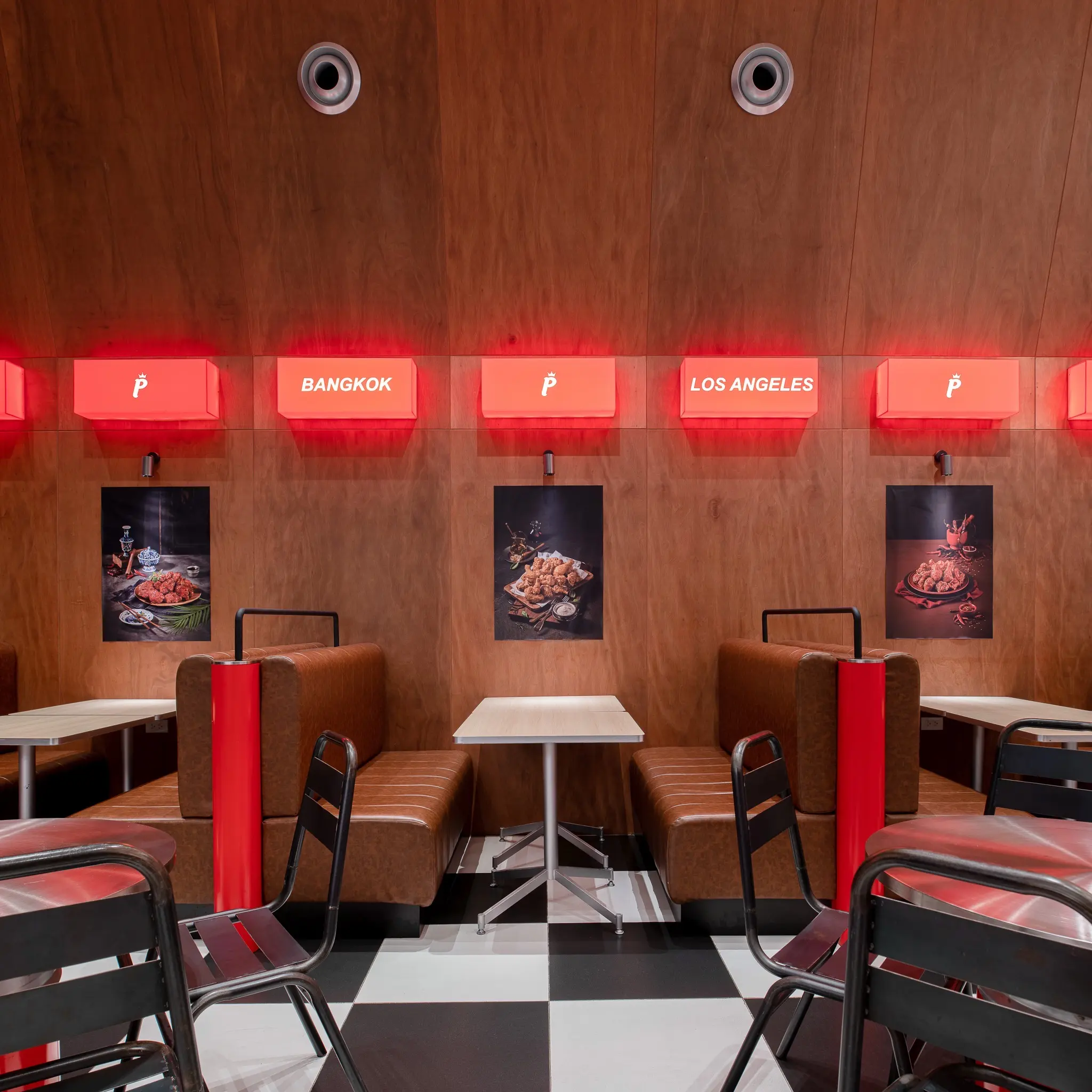 Pelicana WestGate red booth seating and illuminated wall