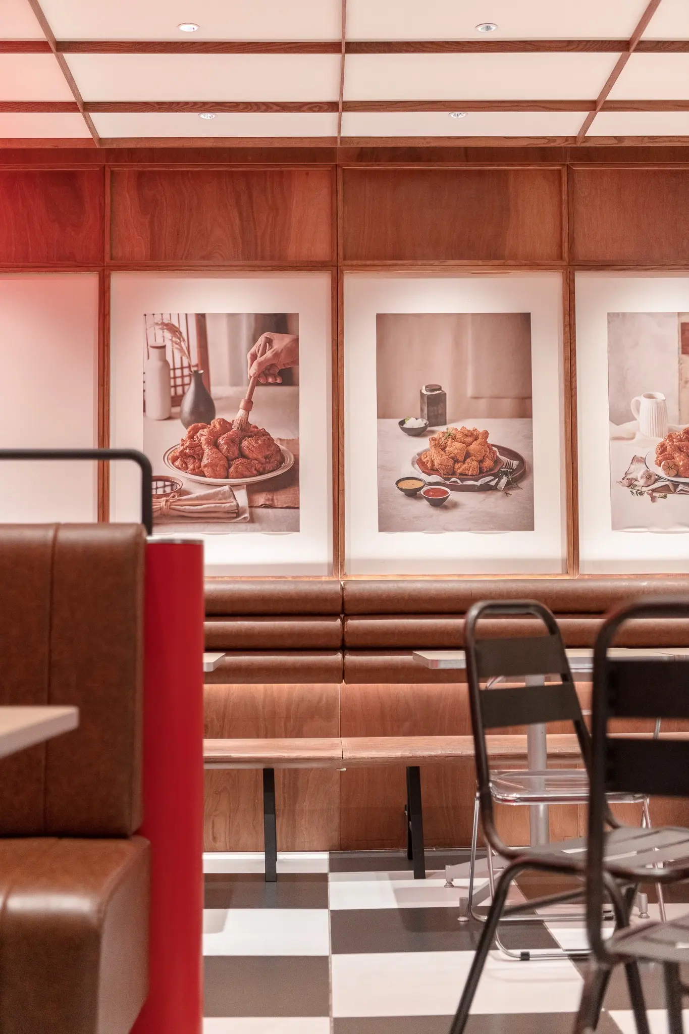 Framed Pelicana food photography above continuous bench seating
