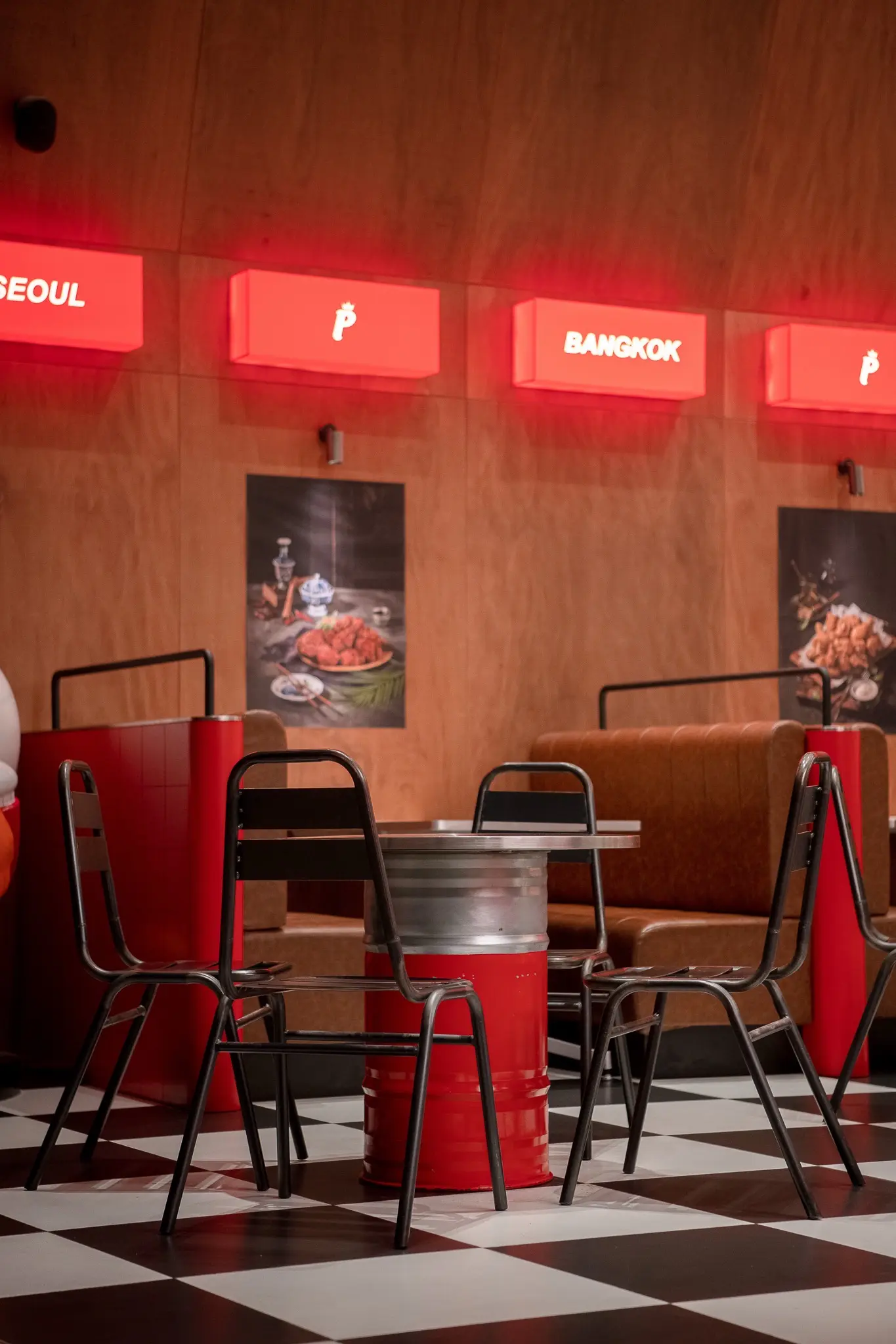 Pelicana WestGate illuminated city-name boxes above seating