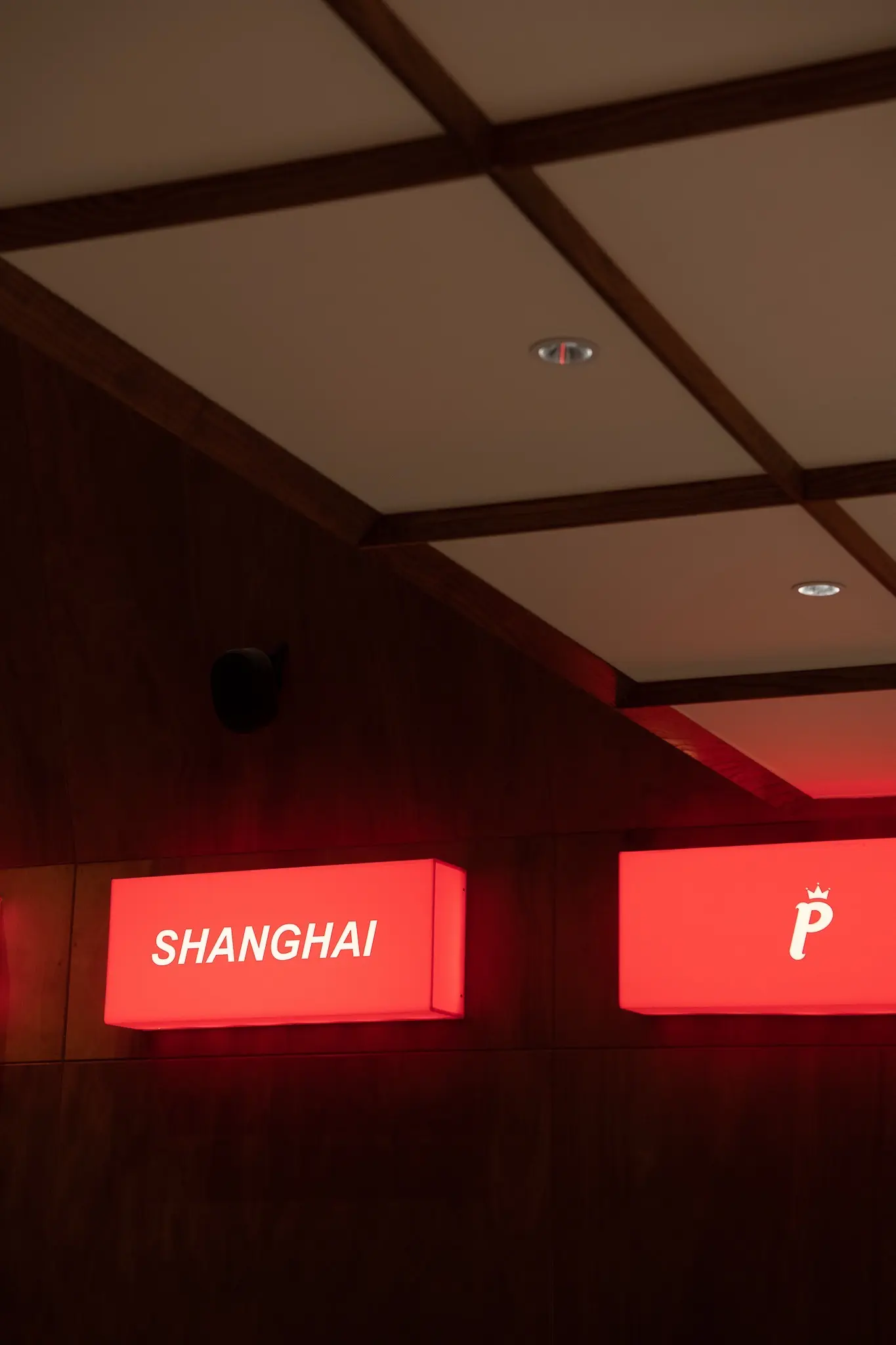 Shanghai illuminated sign integrated into timber wall