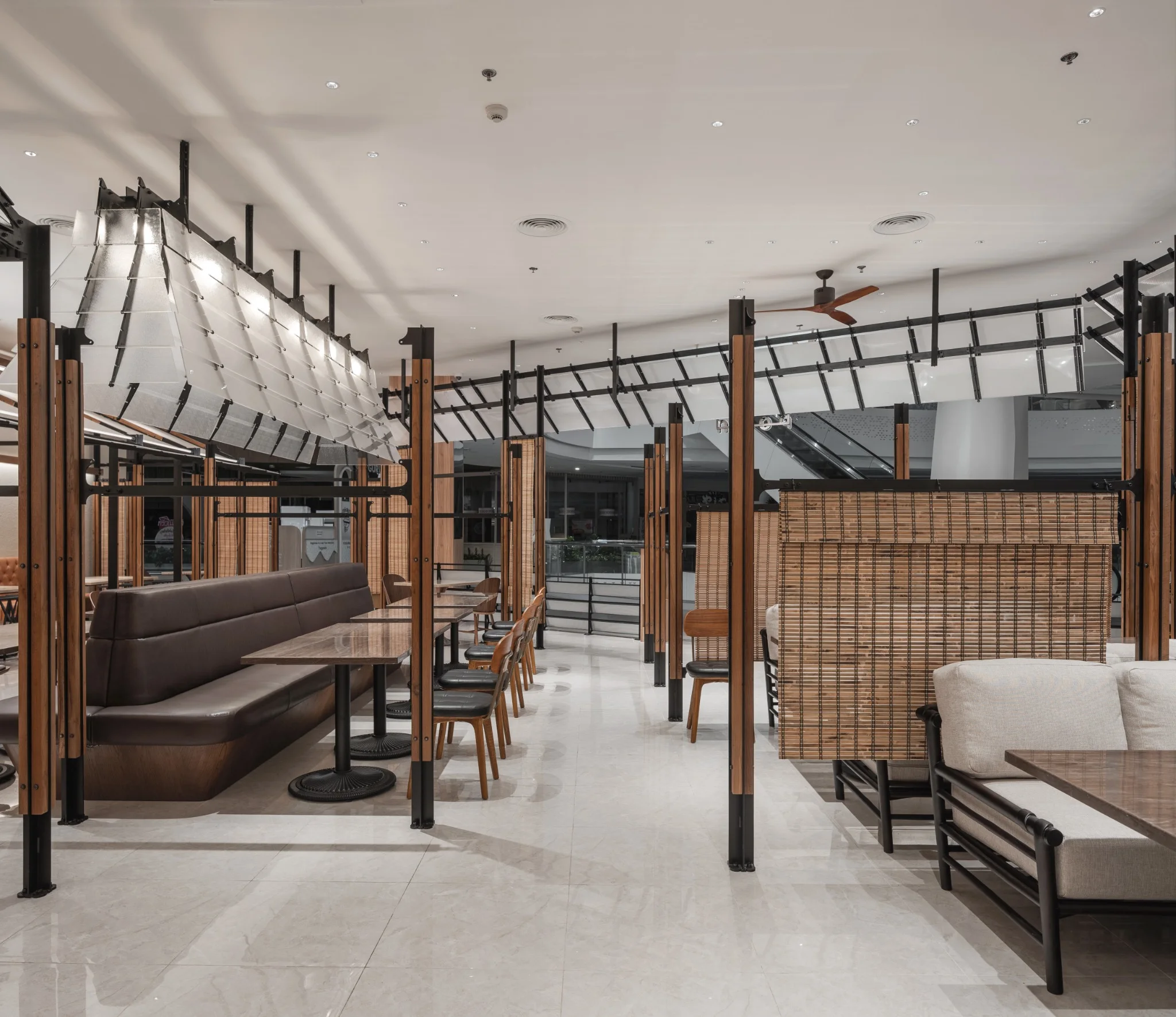 Interior of Ponn Future Park Rangsit with black metal and timber frames organizing booth seating