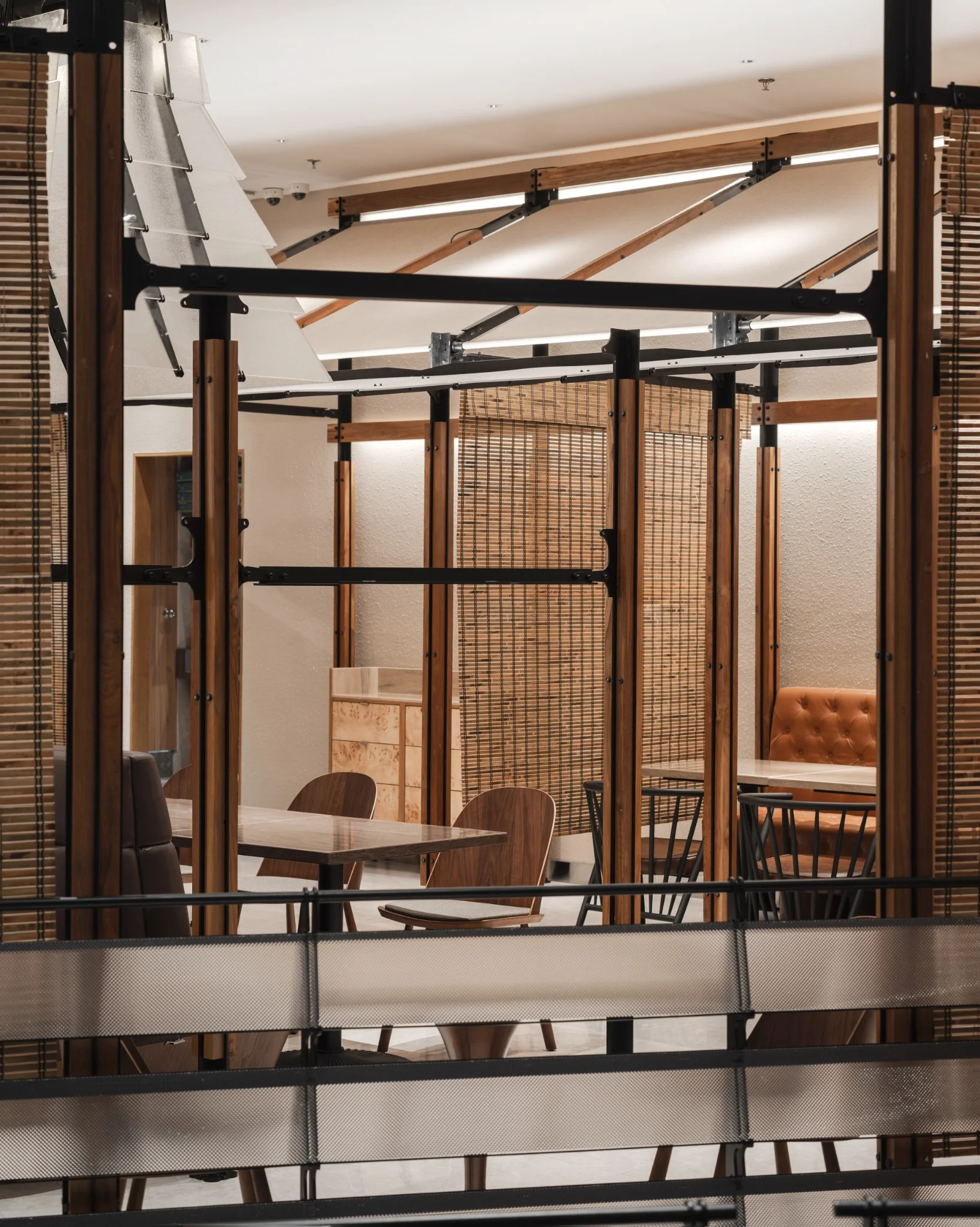 Dining bays framed by black steel, timber and woven screens at Ponn Future Park Rangsit