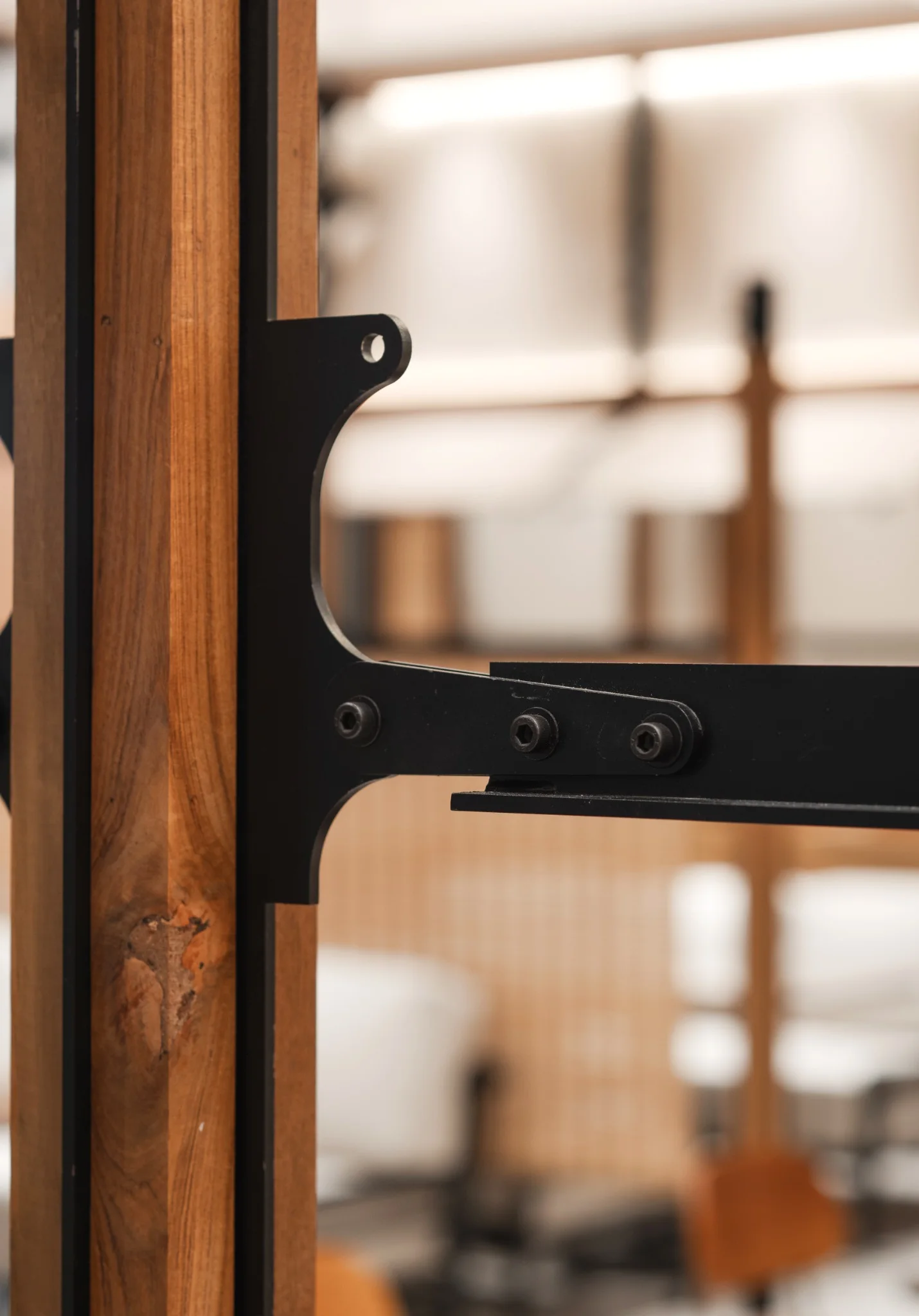 Black metal bracket and timber post joint at Ponn Future Park Rangsit