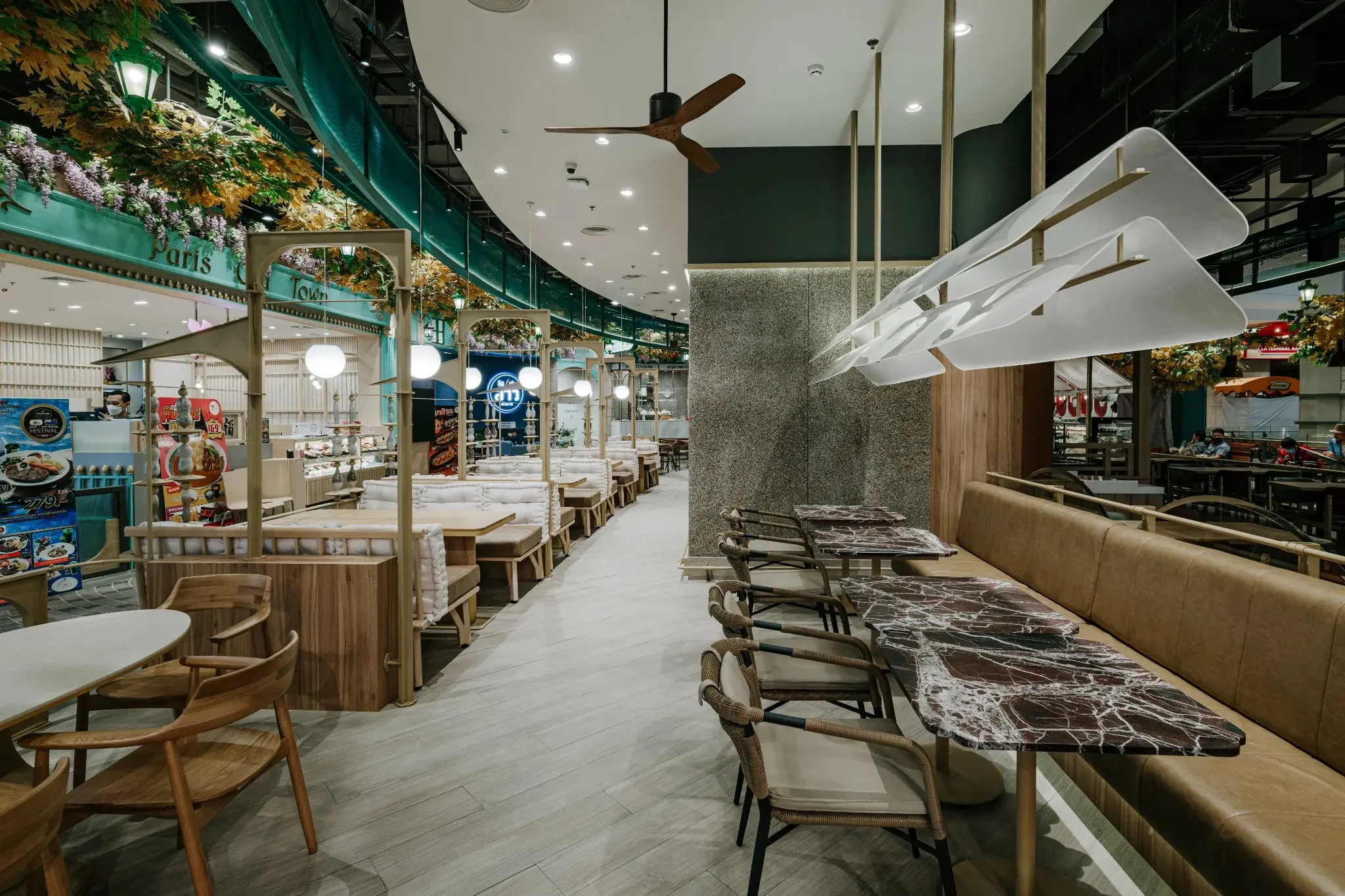 Ponn Terminal 21 Rama 3 dining interior with timber seating and suspended light canopy