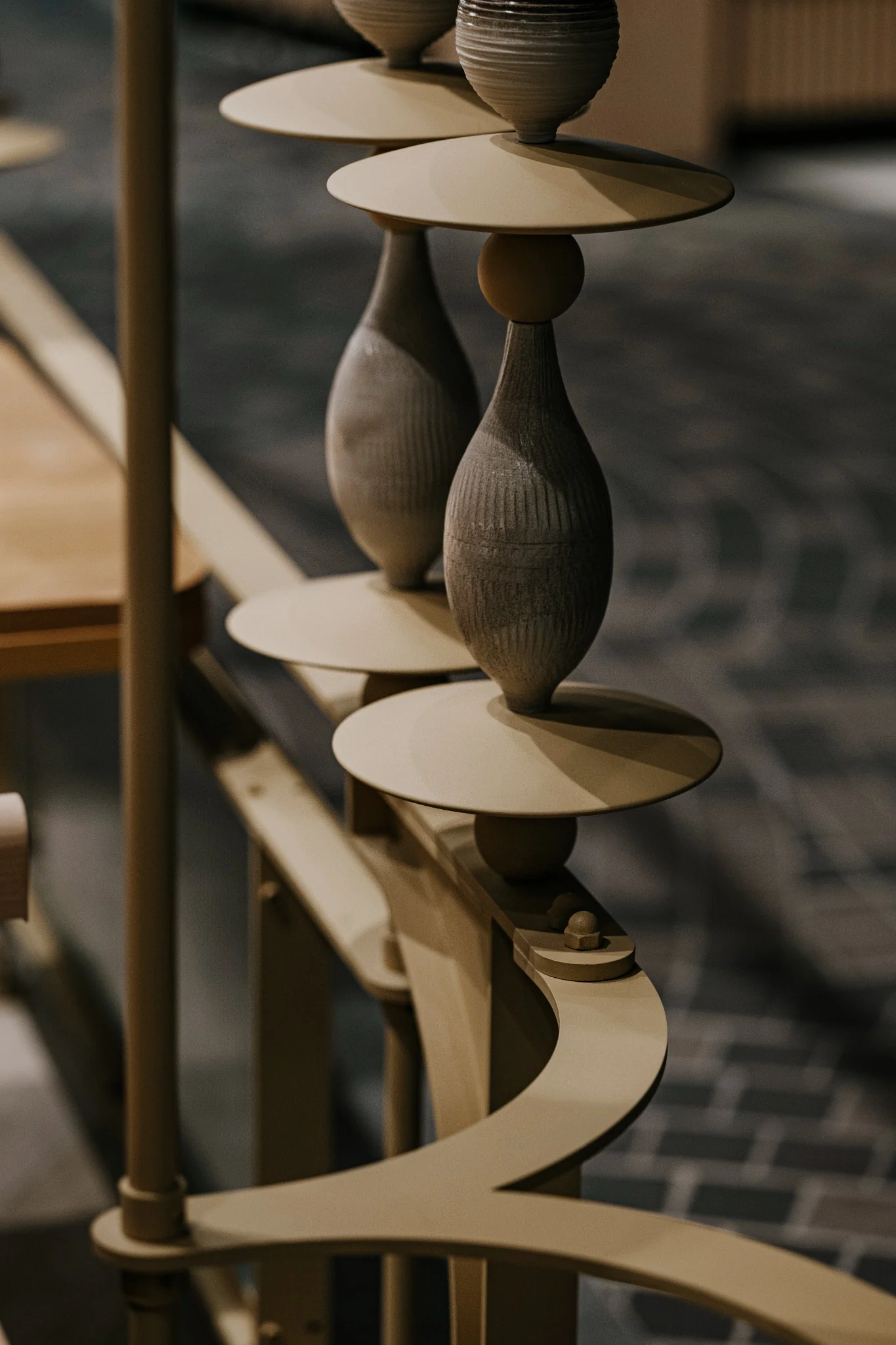 Close view of ceramic pieces and curved custom metal detail at Ponn Terminal 21 Rama 3