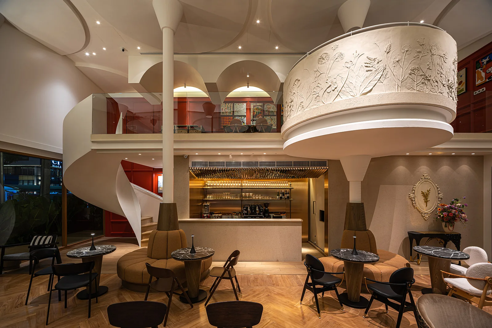 Wide view of the Rosemary dining room, bar, spiral stair and sculptural ceiling