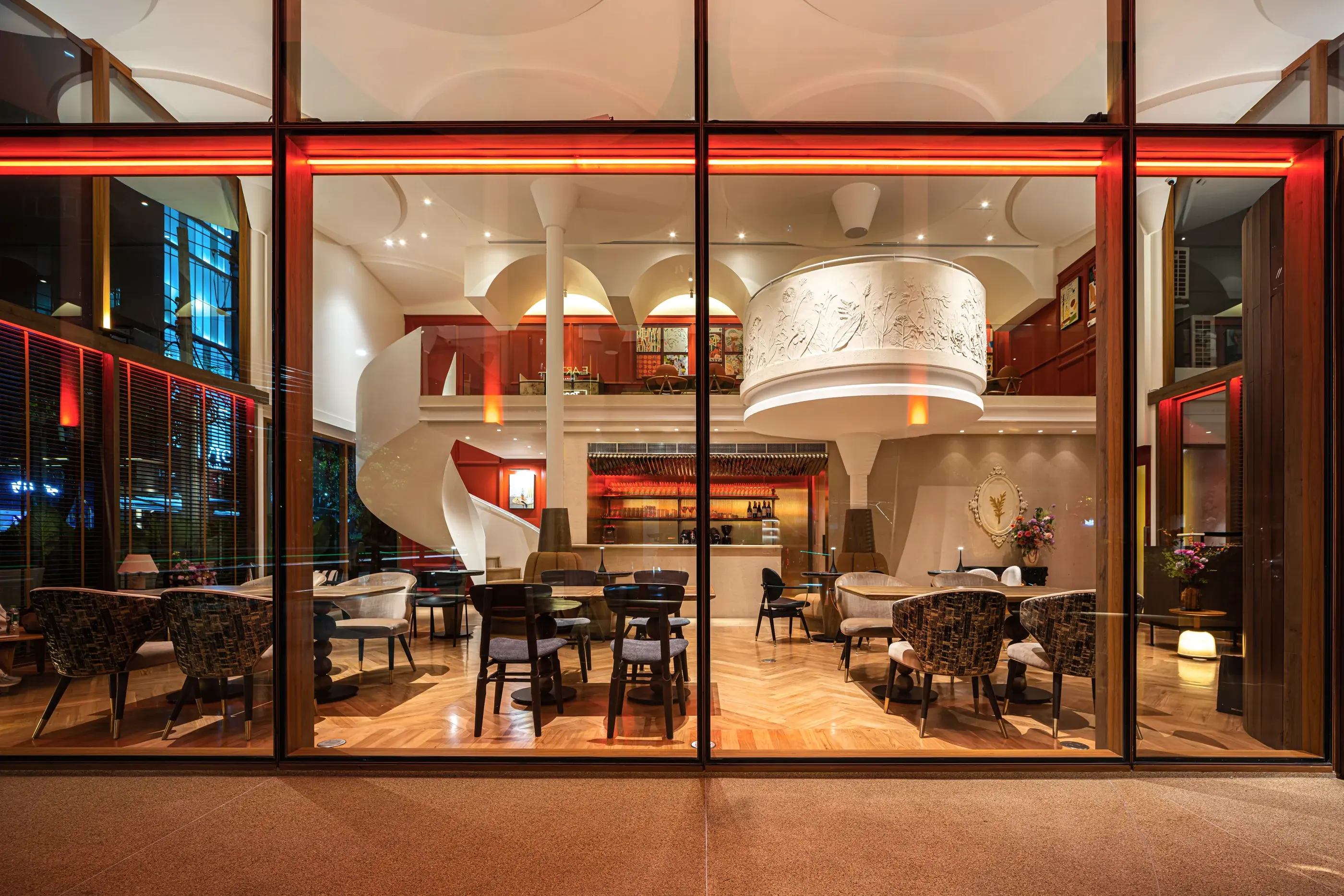 Dining room of Rosemary Everyday Brasserie seen through its full-height glass facade