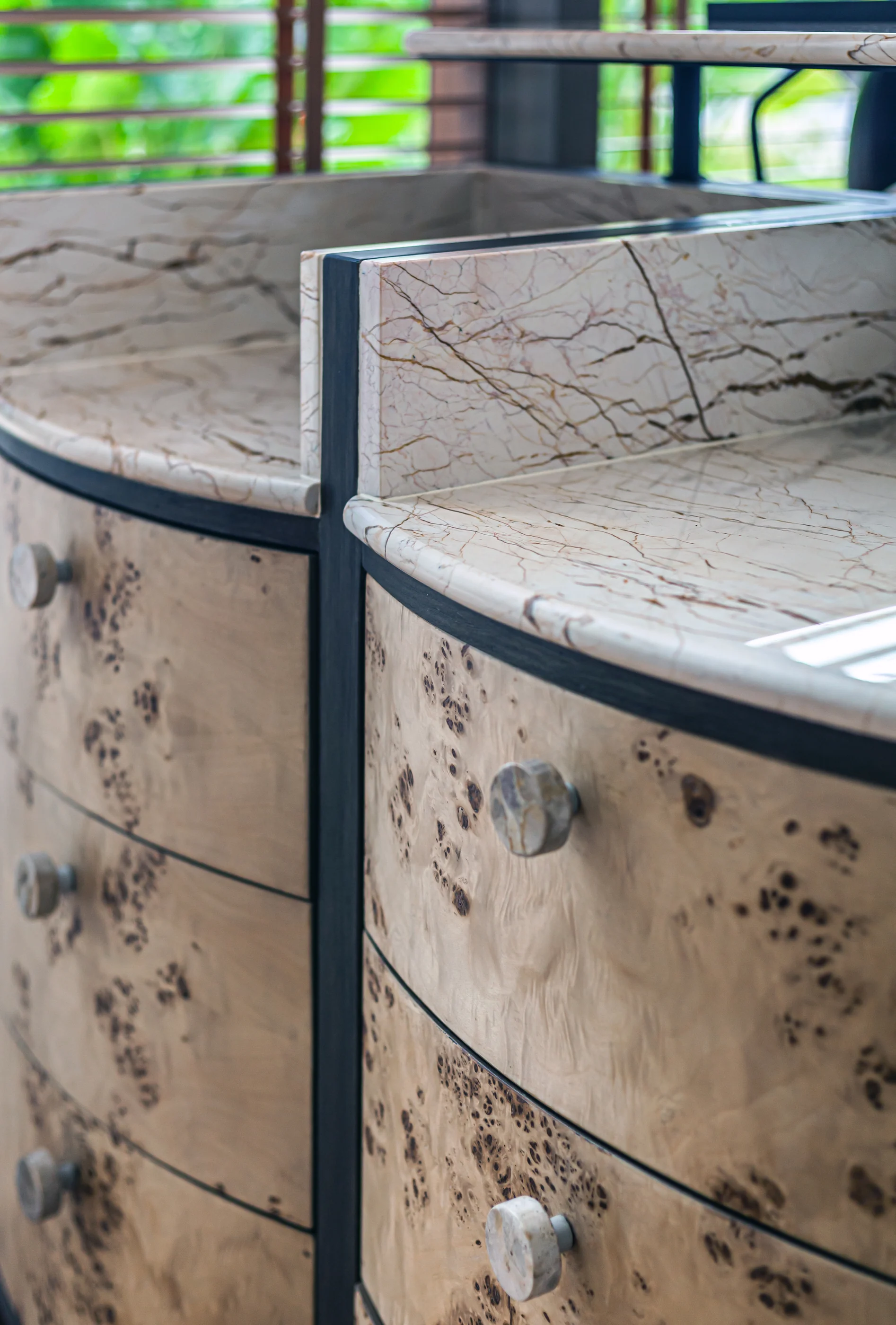 Marble-edged custom cabinet detail with dark metal framing