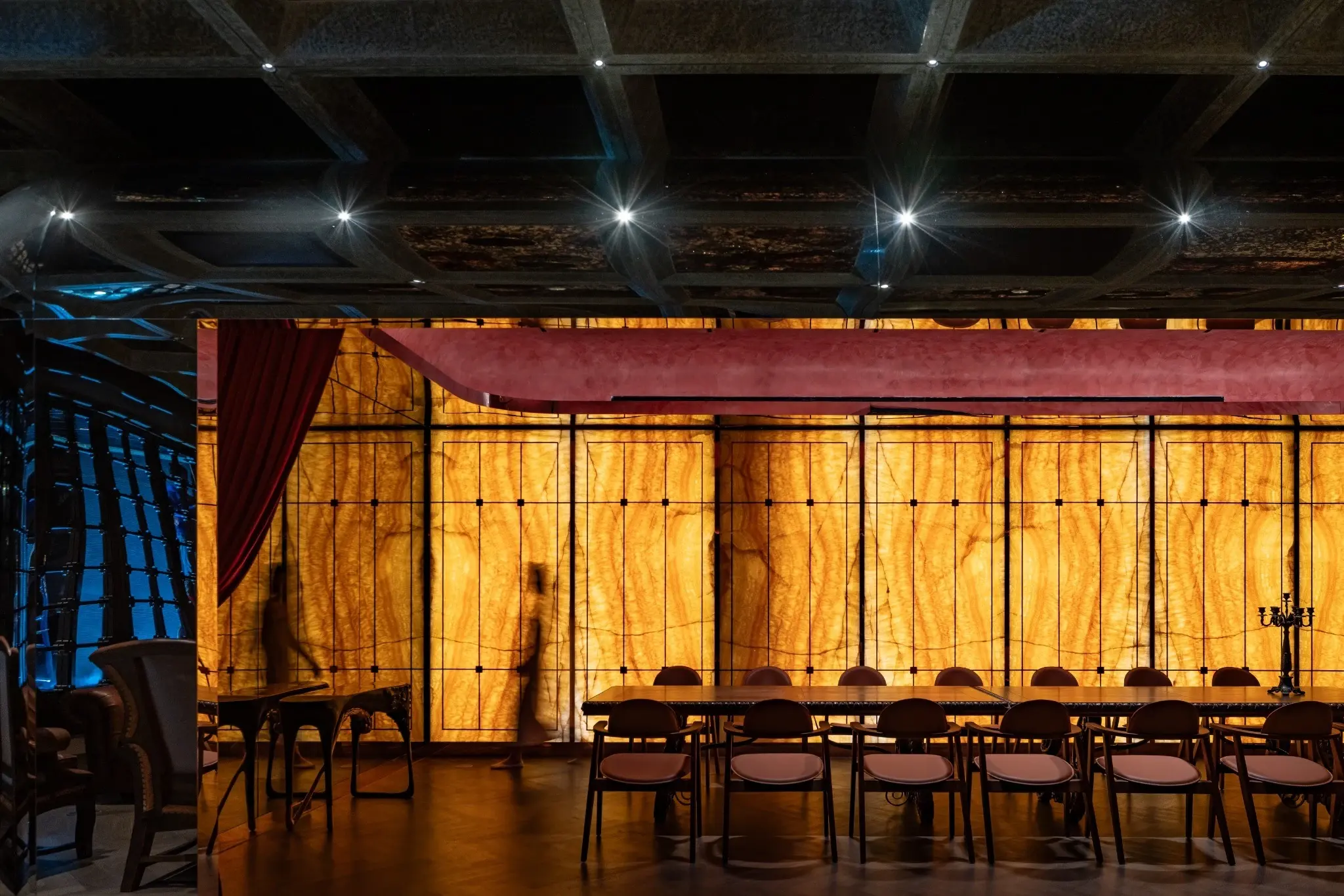 Layered ceiling and wall surfaces inside The Club