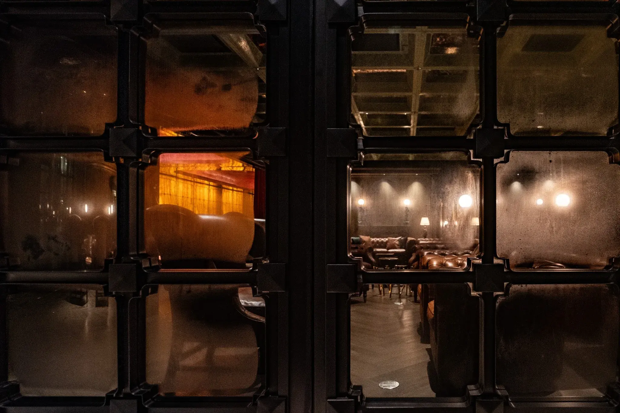Lounge interior with low lighting and reflective surfaces