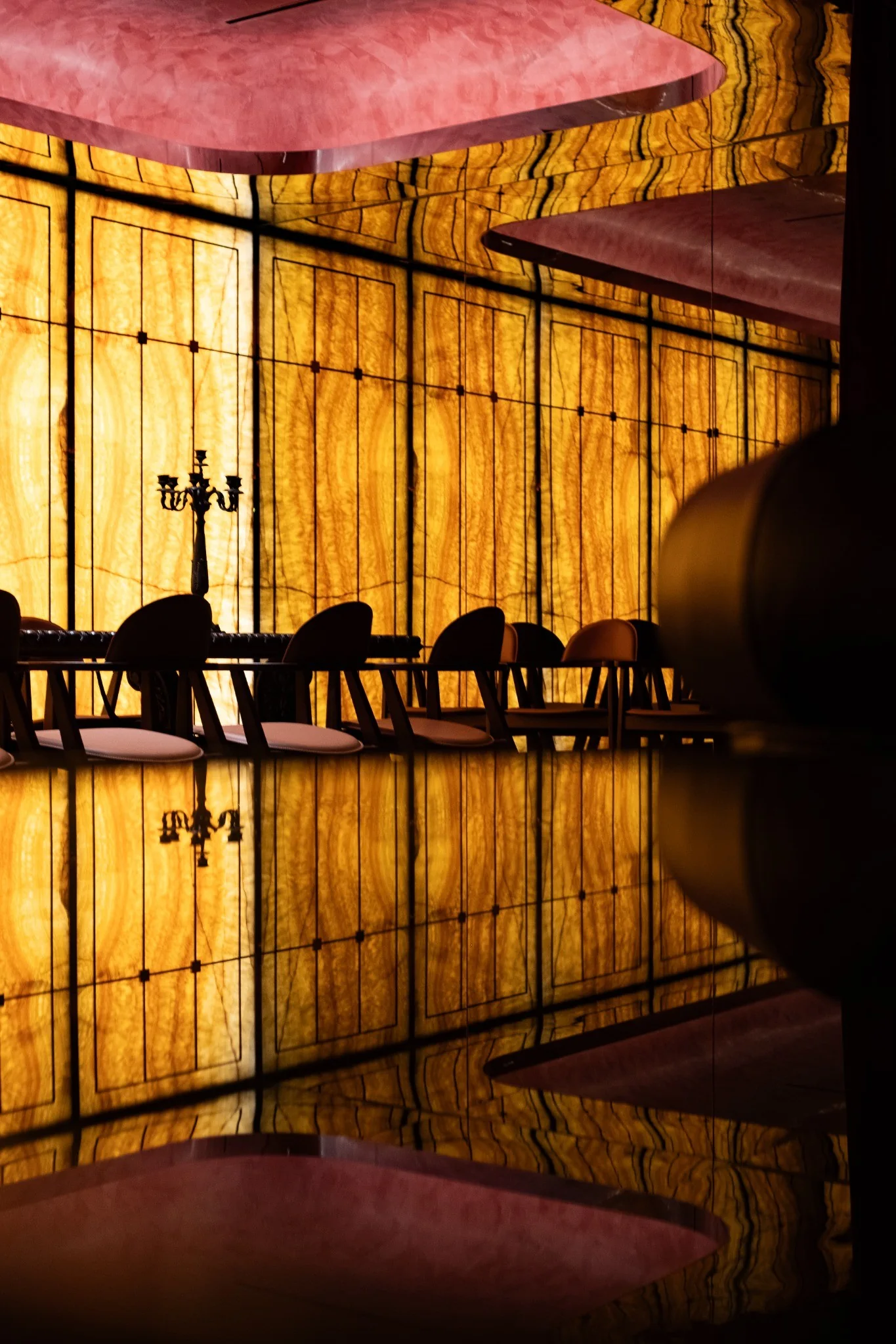 Warm metal and dark material palette in The Club interior