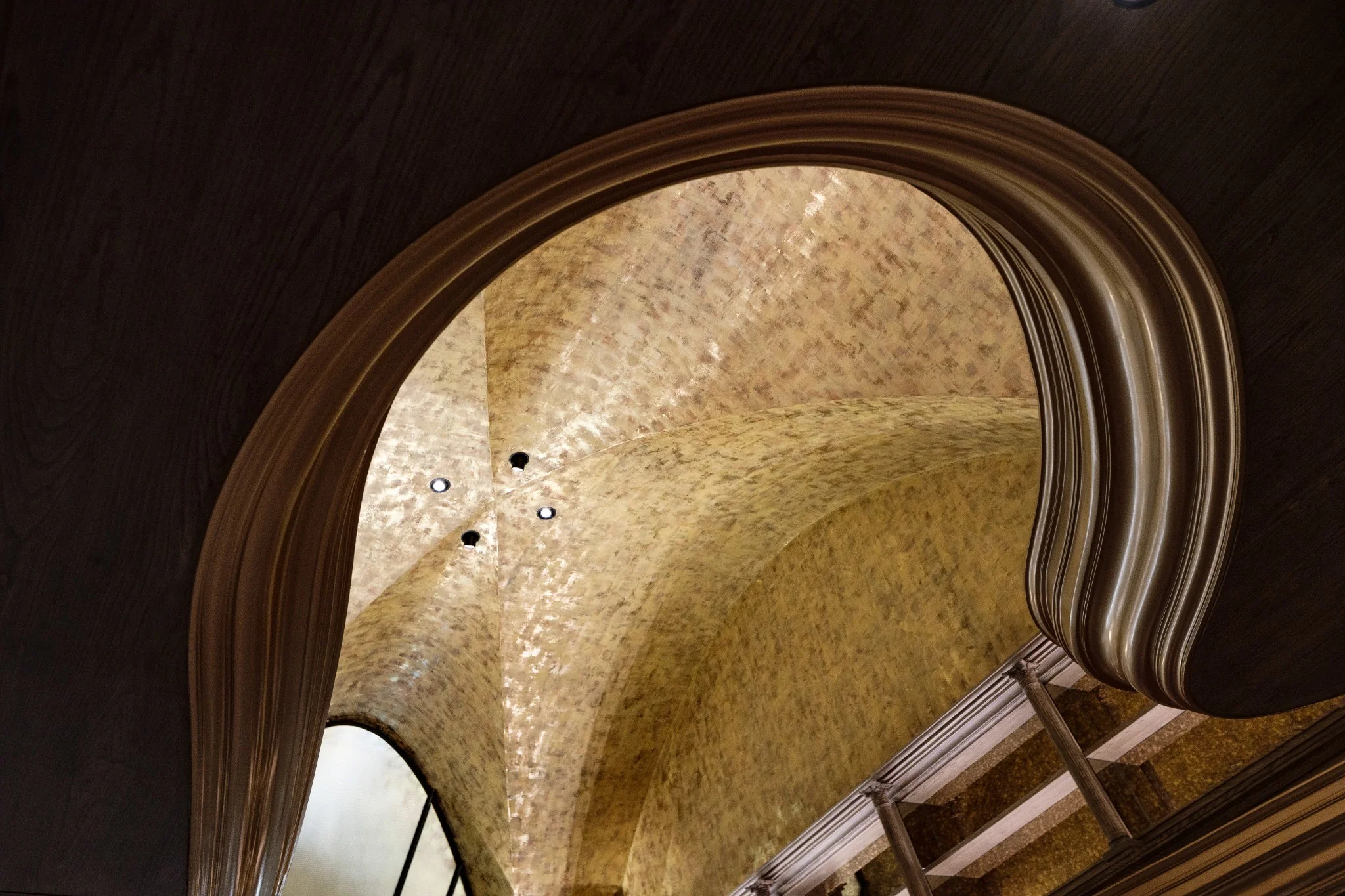 Reflected light across the curved ceiling and wall surfaces