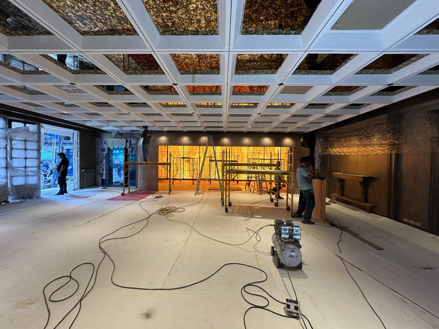 Antique gold mirror ceiling grid installation in The Club Living Hall