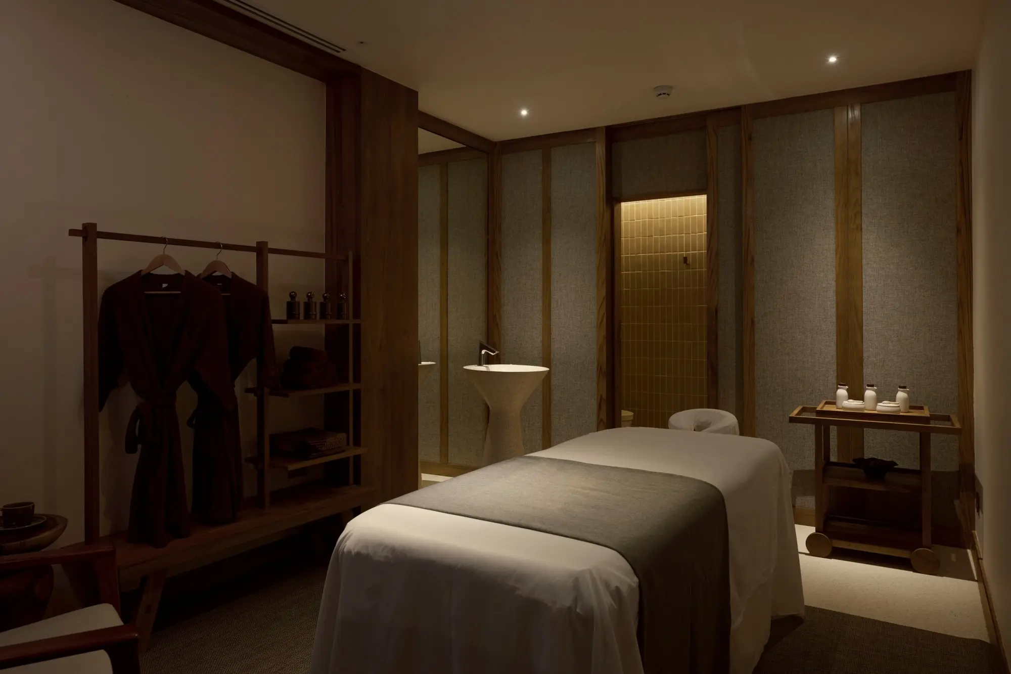 Treatment bed and timber storage at The Retreat Spa