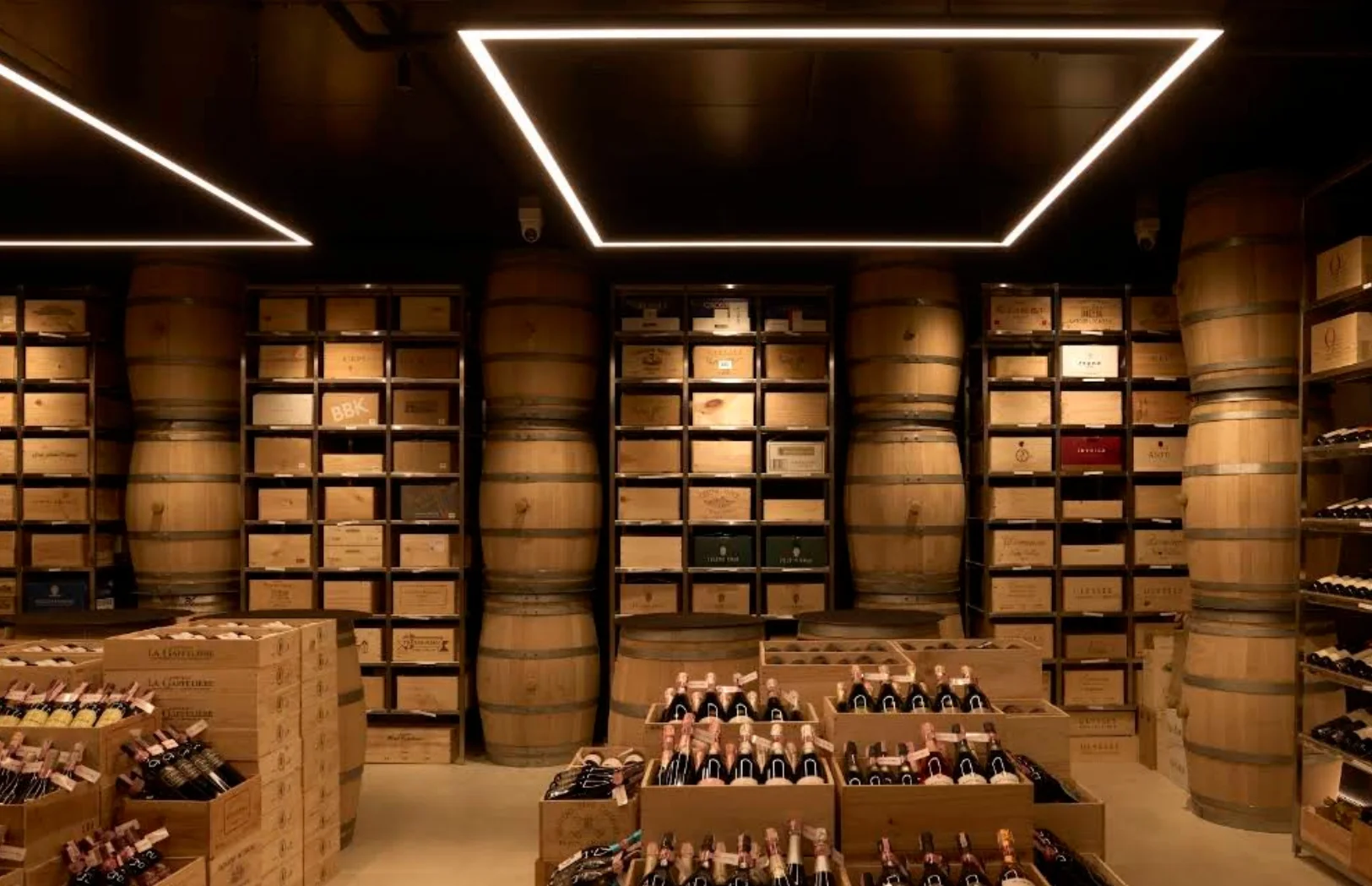 Wine Gallery Bangkok interior with oak barrels, wine crate shelving and geometric ceiling lights