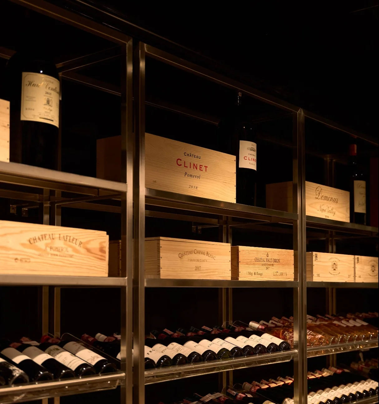 Detail of wine crates and oak barrels within the shelving system at Wine Gallery Bangkok