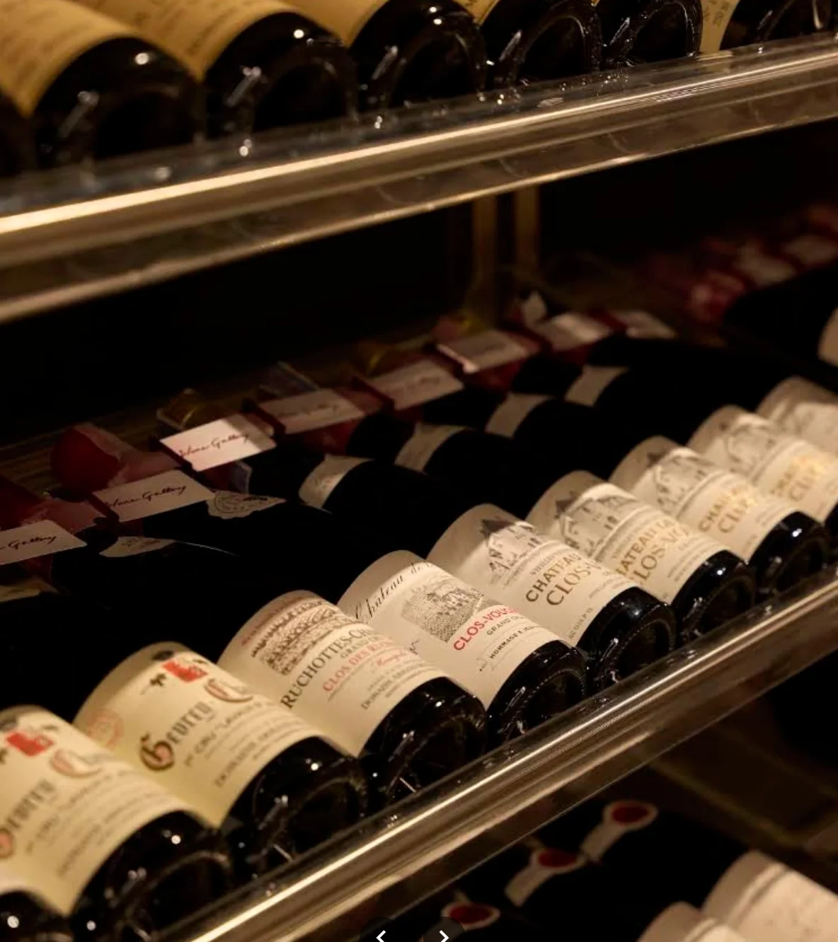 Close view of wine bottles arranged on illuminated racks at Wine Gallery Bangkok